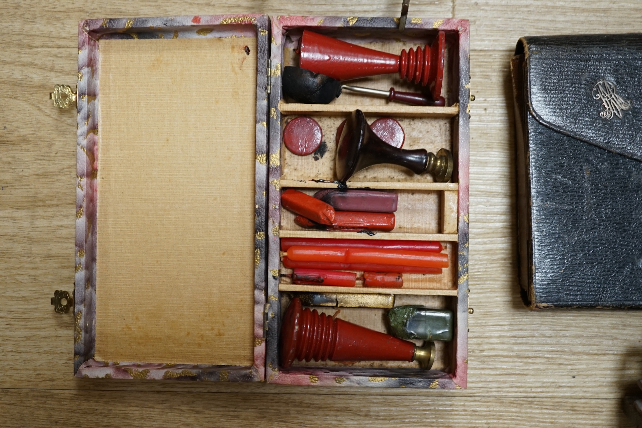 A pair of brass letter scales, a novelty ink pot, a Gladstone bag, a maple framed sketch, a googlie eyed doll’s head, a tin plate Jumbo toy, Dominoes, boxed seal kit and a leather travelling stationary case etc., scales